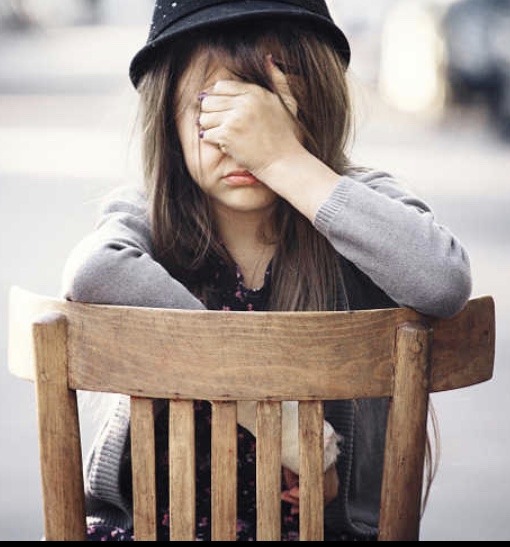 Depressed girl on chair