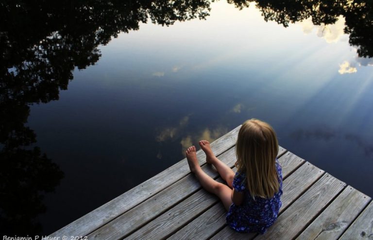 Girl sitting on dock