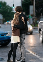 Couple hugging by street